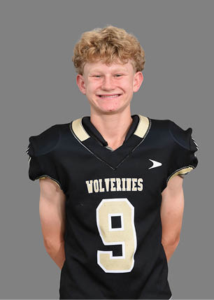 A young man wearing a white and black jersey with the number 14 on it. Description generated by AI