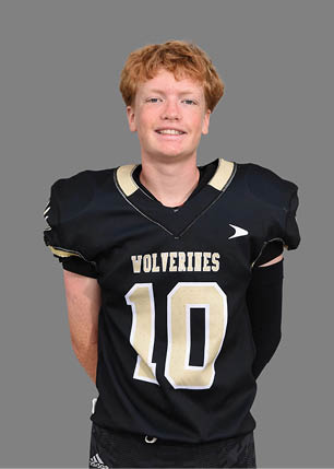 A young man wearing a white and black jersey with the number 14 on it. Description generated by AI