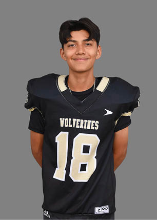 A young man wearing a white and black jersey with the number 14 on it. Description generated by AI