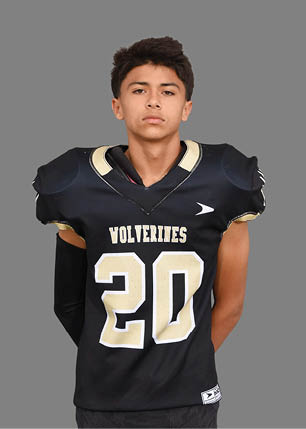 A young man wearing a white and black jersey with the number 14 on it. Description generated by AI
