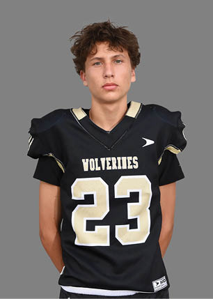 A young man wearing a white and black jersey with the number 14 on it. Description generated by AI