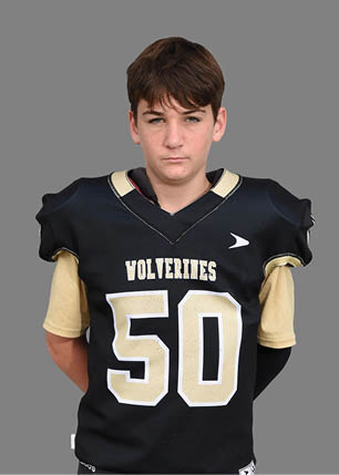A young man wearing a white and black jersey with the number 14 on it. Description generated by AI