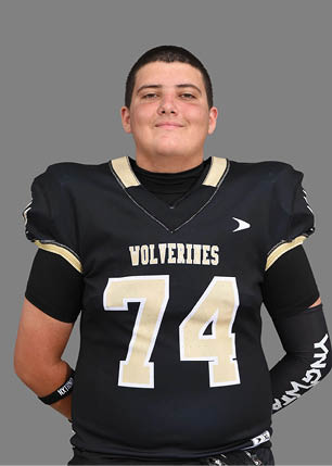 A young man wearing a white and black jersey with the number 14 on it. Description generated by AI
