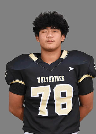 A young man wearing a white and black jersey with the number 14 on it. Description generated by AI