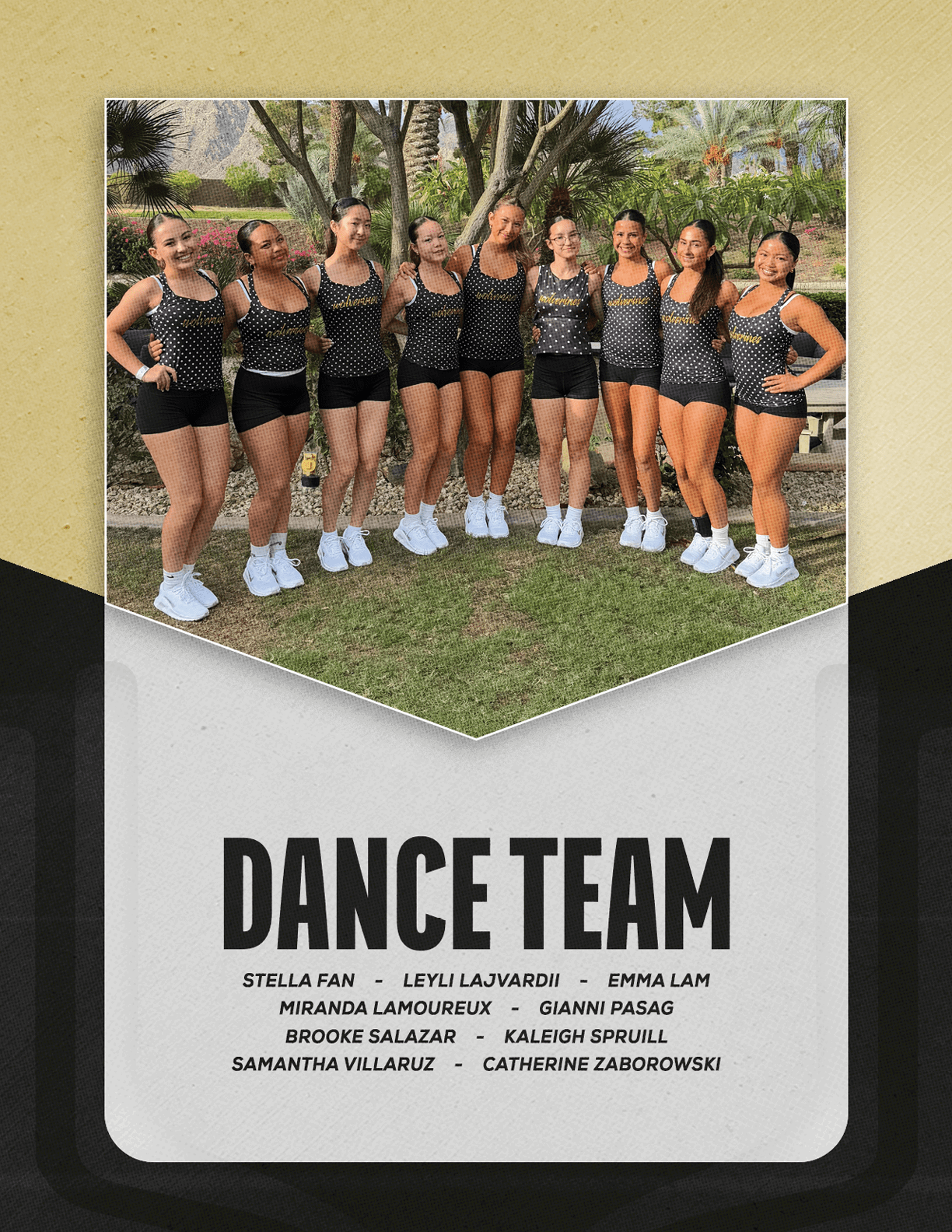 A group of adults wearing matching black and gold dance outfits and white shoes stand closely together outdoors on grass with trees and a bench in the background, above the text dance team 2026. Description generated by AI