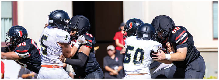 A football player is sliding on the ground. Description generated by AI