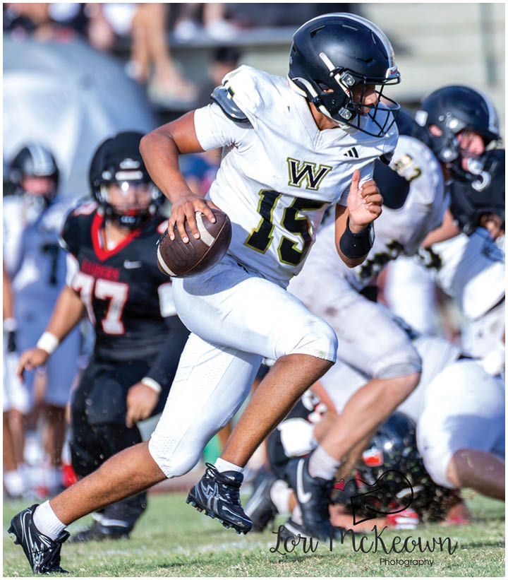 A group of football players wearing black and white uniforms. Description generated by AI