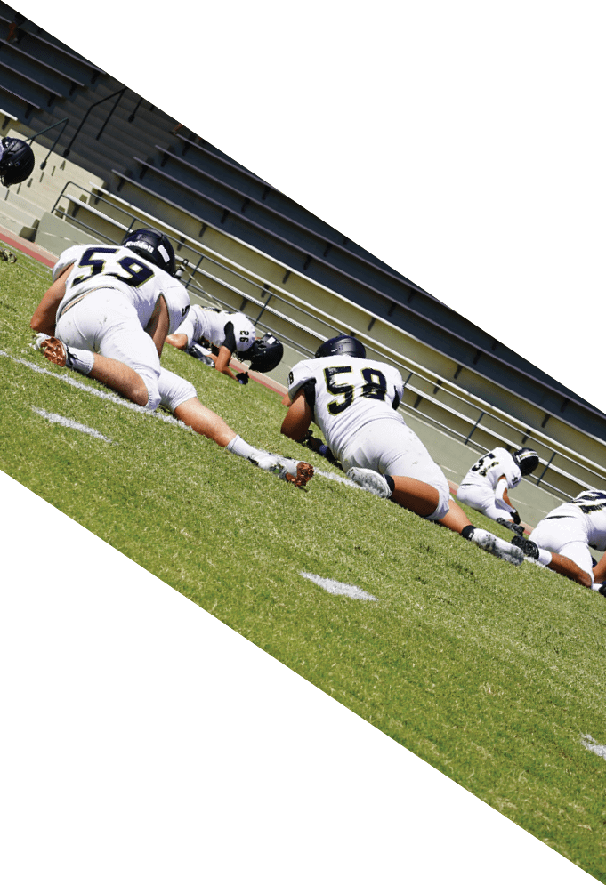 Three football players wearing green uniforms and black helmets pose for a photo. AI generated content