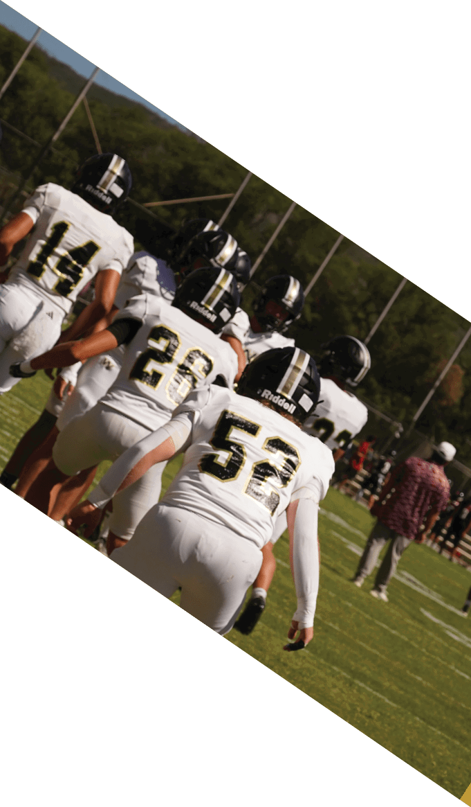 A group of people wearing black jerseys are huddled together on a field. AI generated content