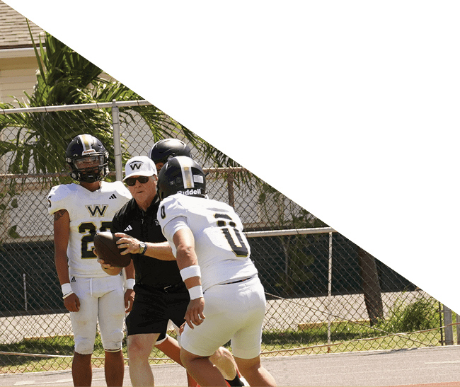 A group of football players kneeling on the field, some with their hands on their heads. AI generated content