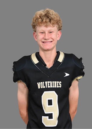 A young man wearing a white and black jersey with the number 14 on it. Description generated by AI