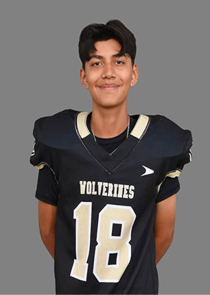 A young man wearing a white and black jersey with the number 14 on it. Description generated by AI