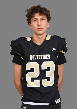 A young man wearing a white and black jersey with the number 14 on it. Description generated by AI