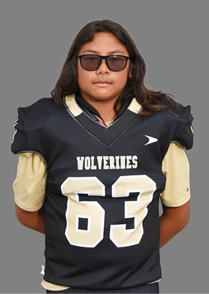 A young man wearing a white and black jersey with the number 14 on it. Description generated by AI