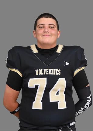 A young man wearing a white and black jersey with the number 14 on it. Description generated by AI