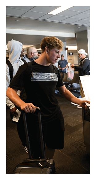 A football player is kneeling on the field, wearing a green jersey and a helmet. AI generated content