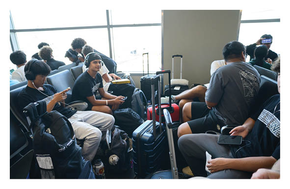 A group of football players wearing headphones and smiling. AI generated content