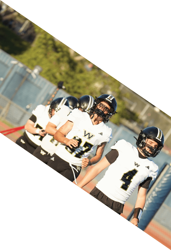 A group of young men wearing black and white uniforms are standing on a field. AI generated content