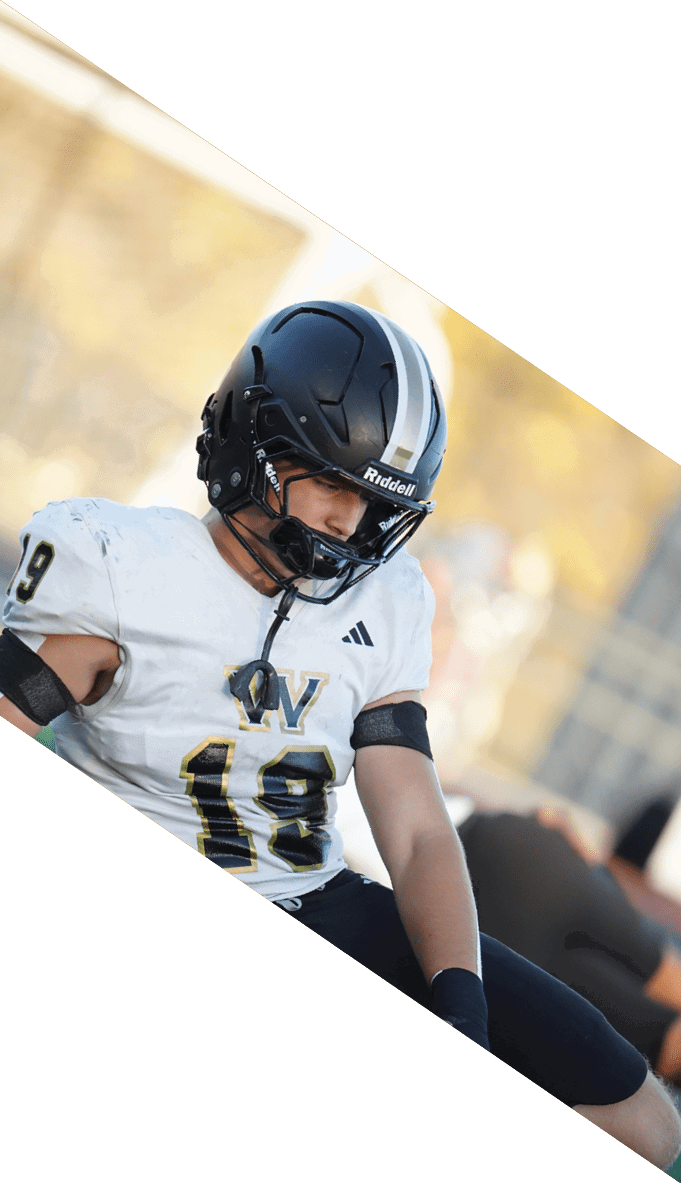 A football team is gathered around a coach, listening to his instructions. AI generated content