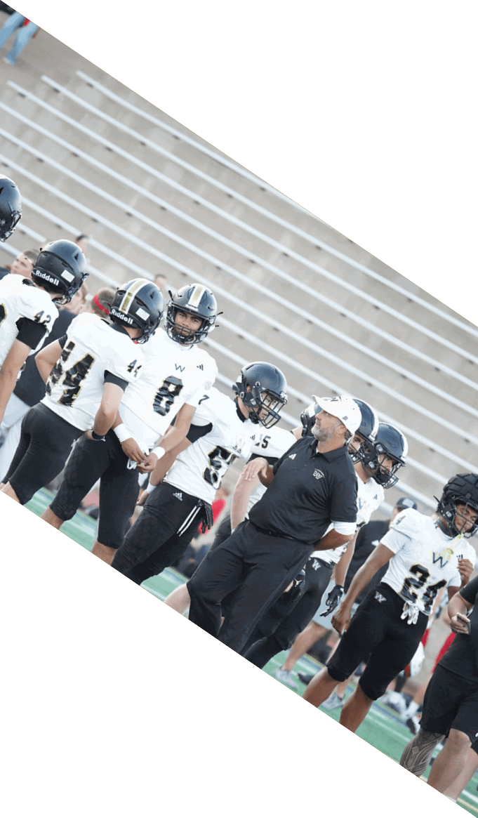 A group of people wearing black jerseys are huddled together on a field. AI generated content