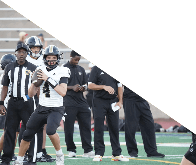 A group of football players kneeling on the field, some with their hands on their heads. AI generated content