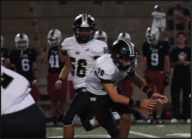 A group of football players in black and white uniforms are on the field. AI generated content