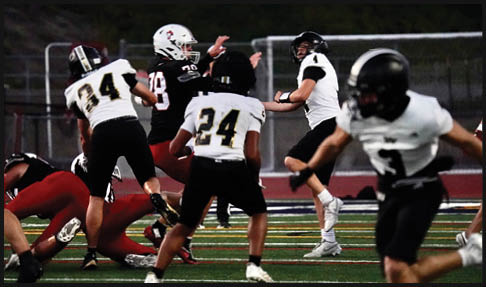 Two men wearing football uniforms are hugging each other on a field. AI generated content