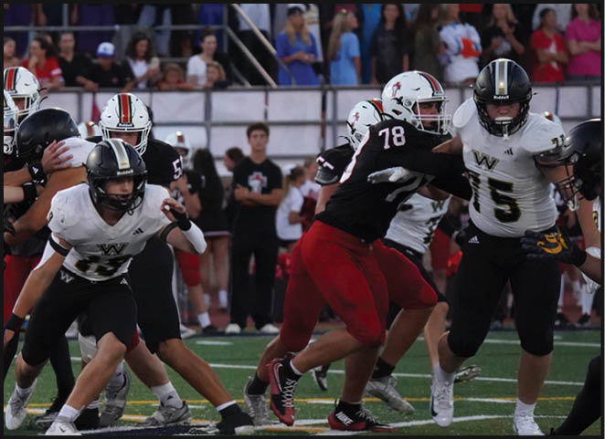 A group of football players in black and white uniforms are on the field. AI generated content
