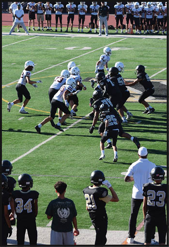 A football player running on the field. Description generated by AI