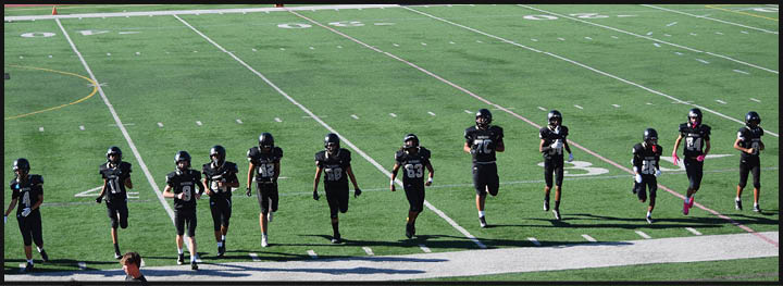 A football player is sliding on the ground. Description generated by AI