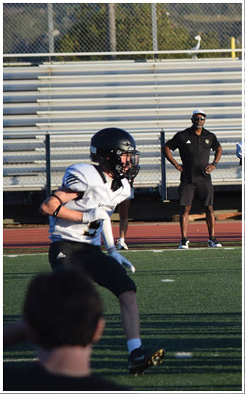 A football player running on the field. Description generated by AI