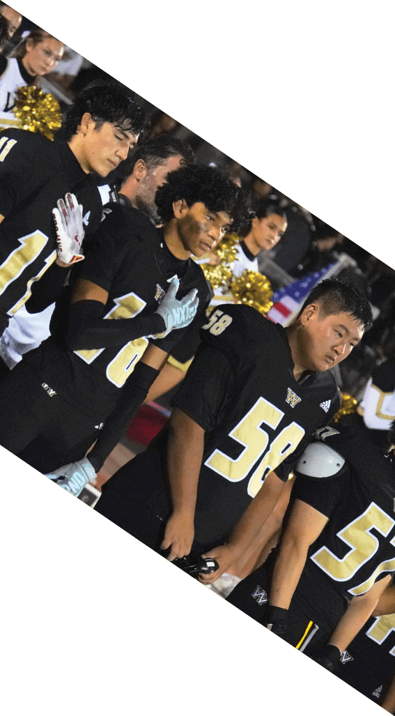 A football player wearing a black helmet and white jersey is holding a football in his hands. AI generated content