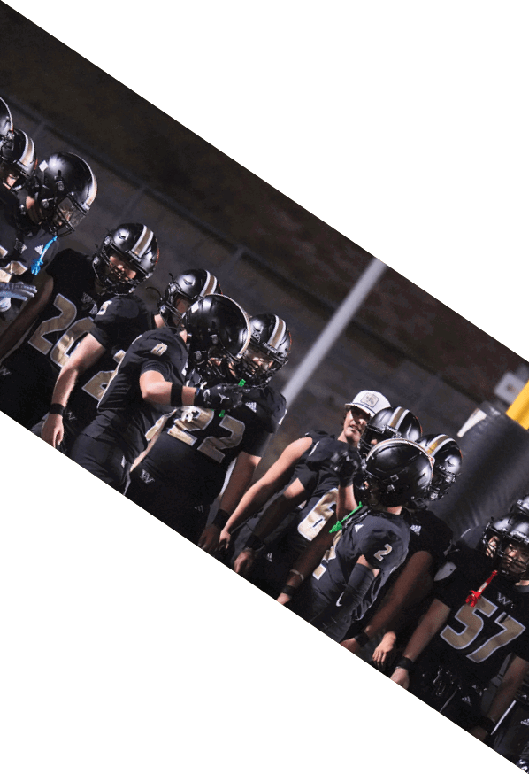 A group of young men wearing black and white uniforms are standing on a field. AI generated content