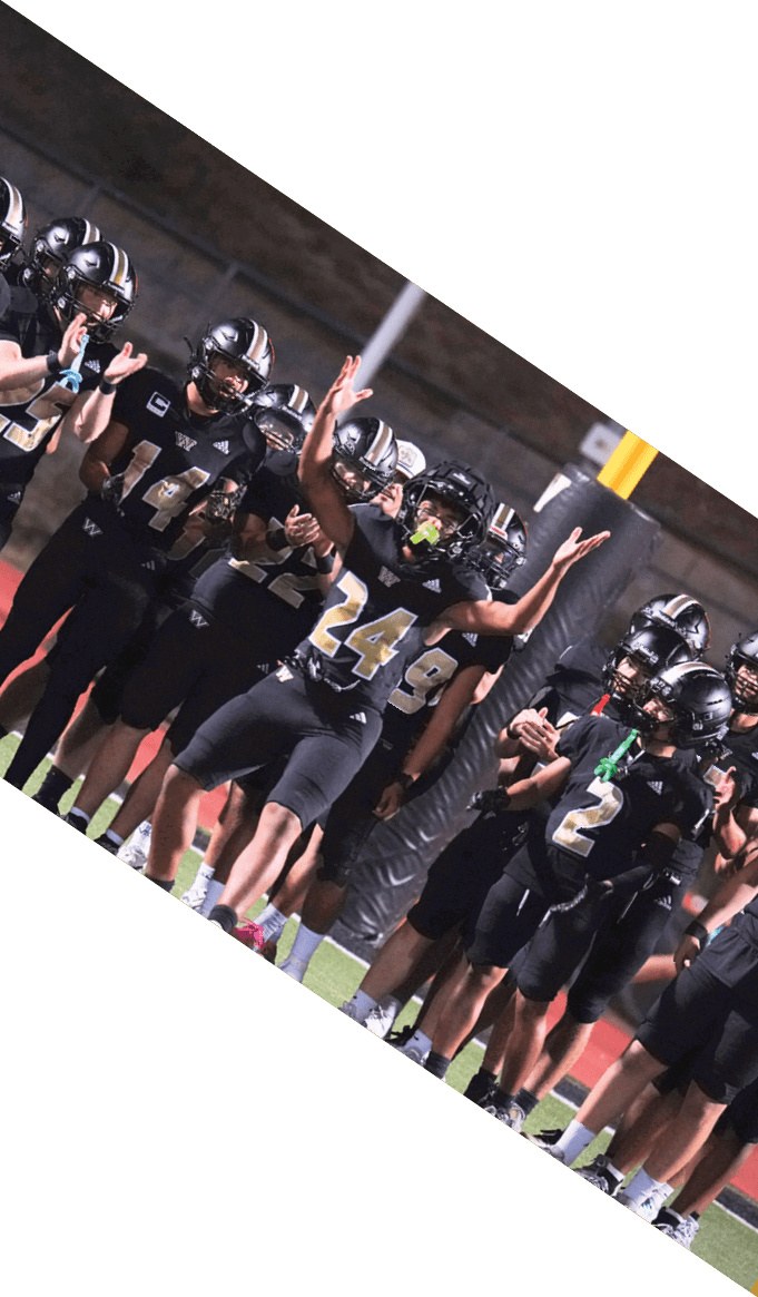 A group of people wearing black jerseys are huddled together on a field. AI generated content