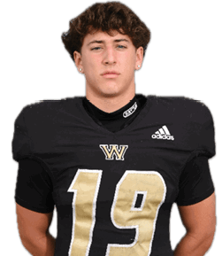 A person with short curly hair wearing a black football jersey with the number 19 and a “W" logo stands facing forward against a white background. Description generated by AI
