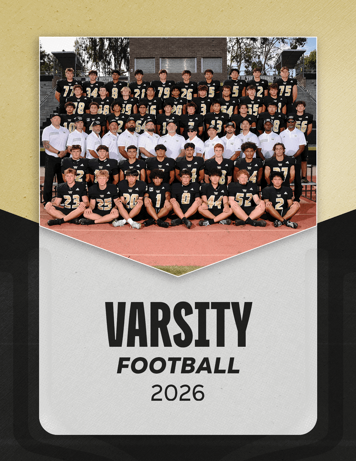 A large group of people wearing black football uniforms and white shirts pose together on bleachers above a track with the text varsity football 2026 below them. Description generated by AI