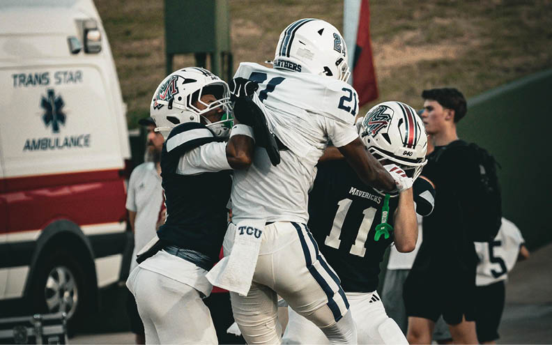 A football player wearing a blue and white jersey with the number 11 on it. Description generated by AI