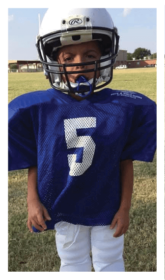 A football player wearing a blue and red jersey. Description generated by AI