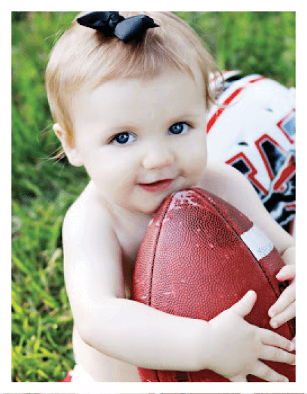 A football player wearing a blue and red jersey. Description generated by AI