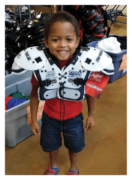 A football player wearing a blue and red jersey. Description generated by AI
