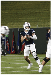 A group of football players celebrating a touchdown. Description generated by AI