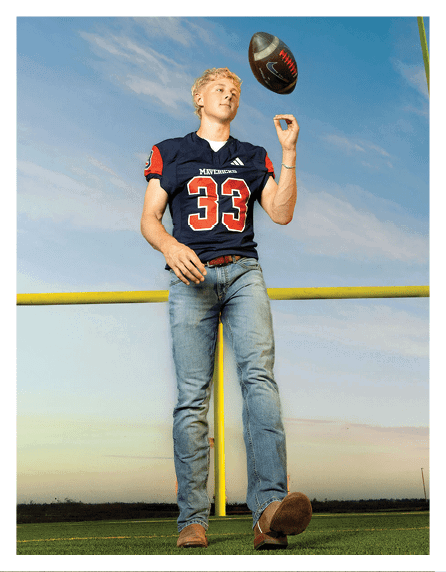 A football player wearing a blue and red jersey. Description generated by AI