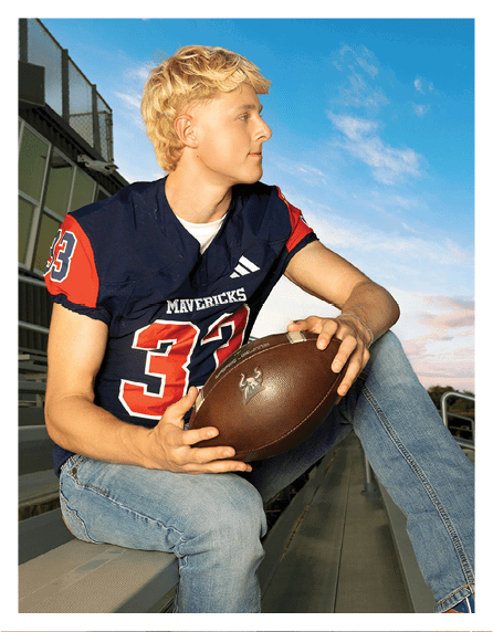 A football player wearing a blue and red jersey. Description generated by AI