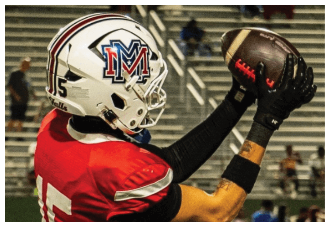A football player wearing a blue and red jersey. Description generated by AI