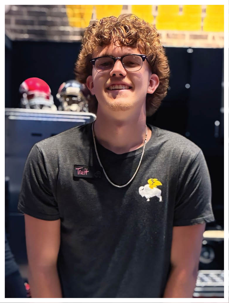A football player wearing a blue and red jersey. Description generated by AI