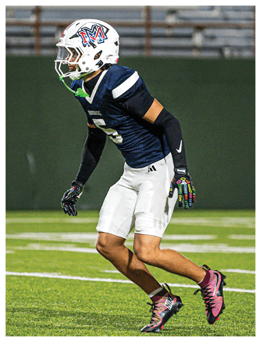A football player wearing a blue and red jersey. Description generated by AI