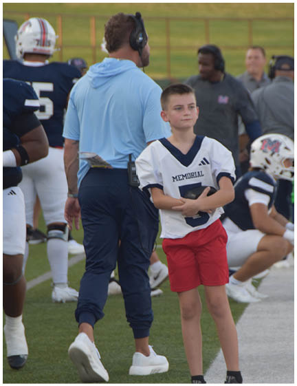 A football player wearing a blue and red jersey. Description generated by AI