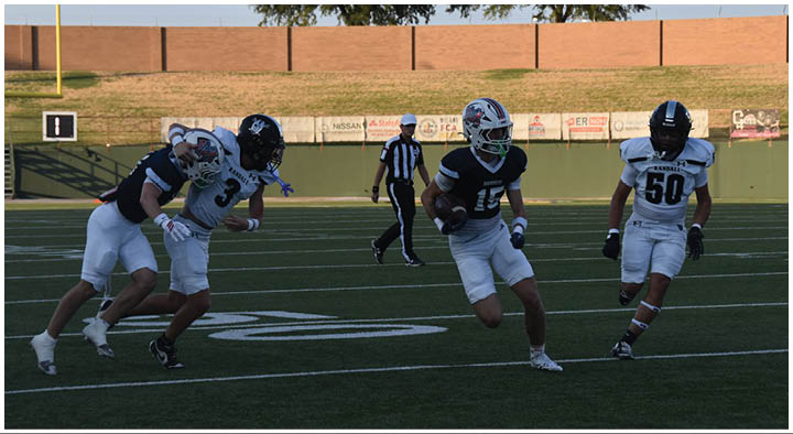 A group of football players on a field. Description generated by AI