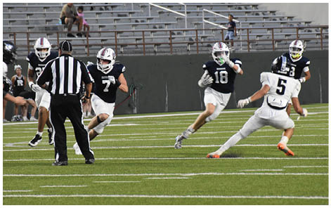 A group of football players on a field. Description generated by AI