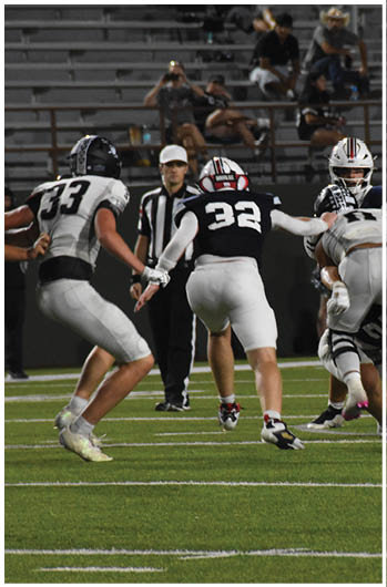 A group of football players on a field. Description generated by AI